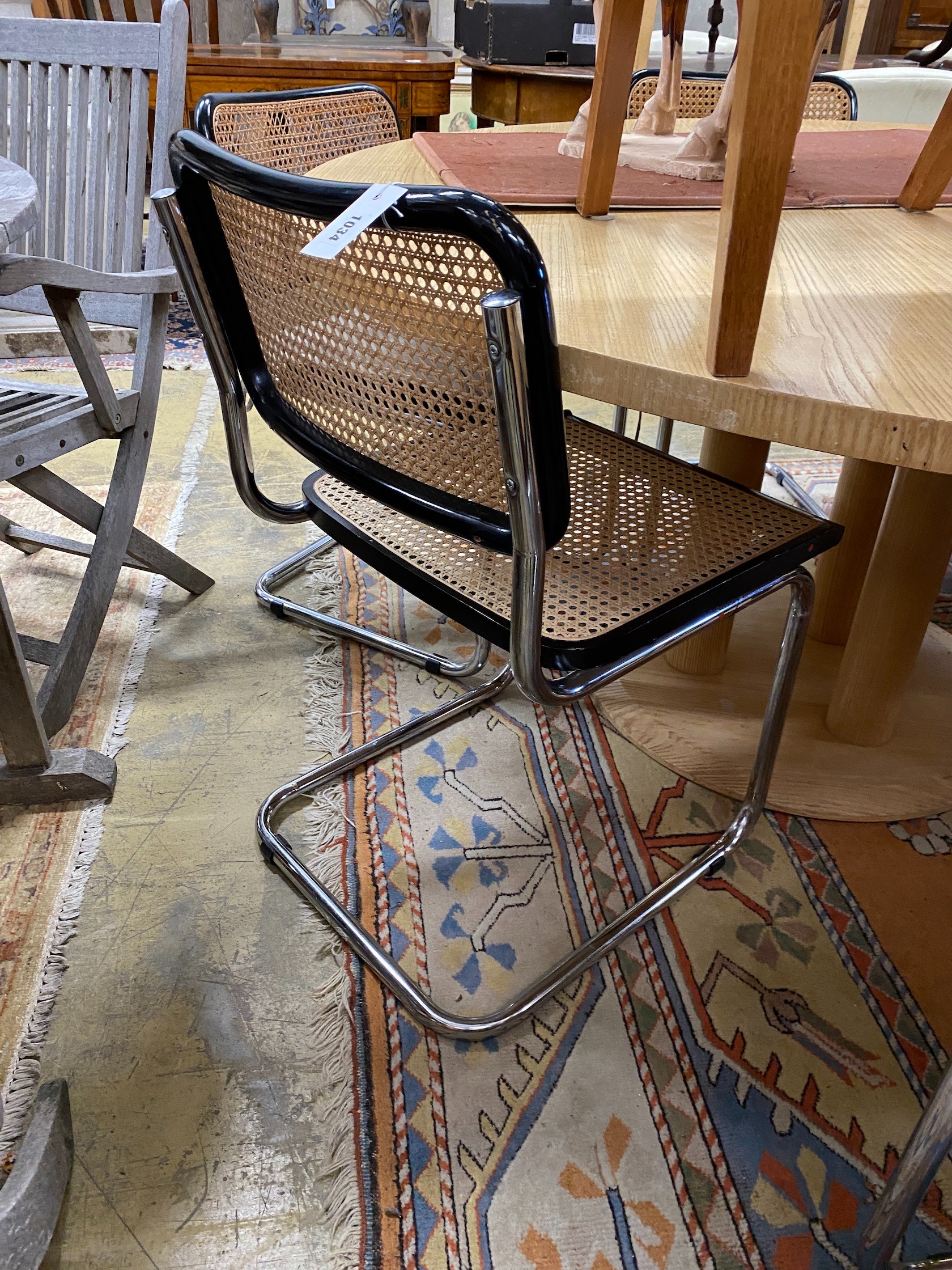 Six caned ebonized cantilever dining chairs in the style of Knoll Cesca by Marcel Breuer